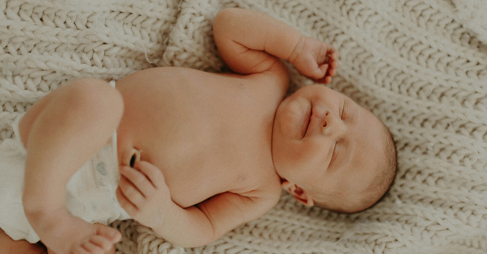 Small-Baby-Has-Dummy-Lies-Bed