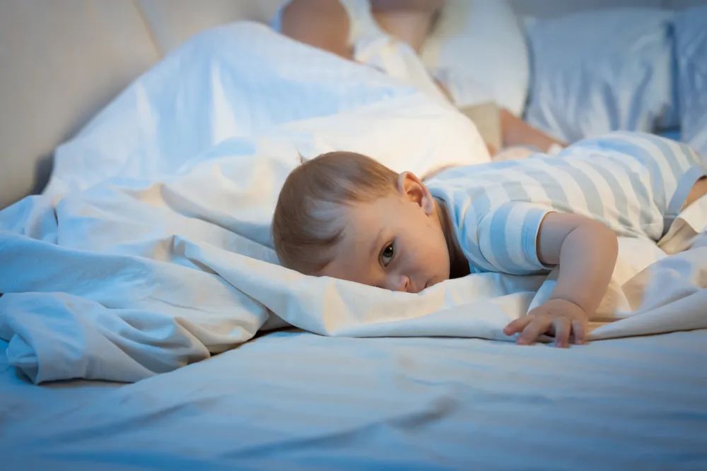 Baby lying on the bed