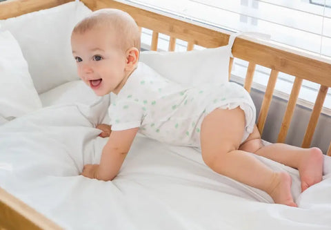 A Baby Lying On The Crib