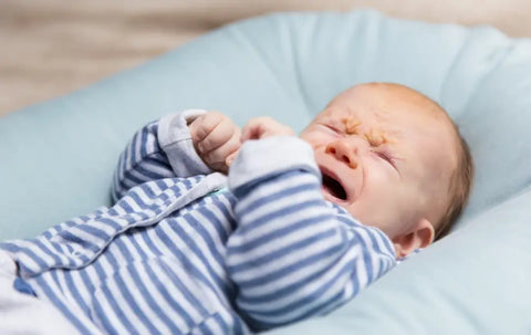 A Crying Baby In Blue Clothes