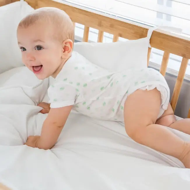 A cute baby lying on the crib