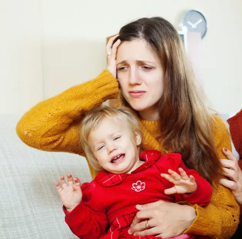 A Distressed Mother Holds Her Crying Daughter In Her Arms