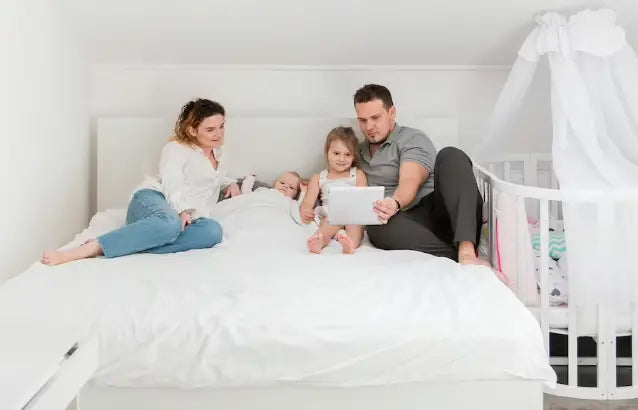 A Harmonious Family Of Four Lying On The Bed