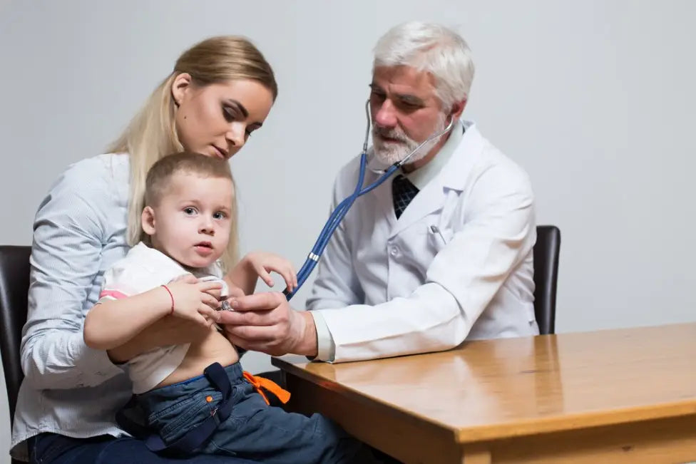A Pediatrician Is Diagnosing A Little Boy With A Stethoscope