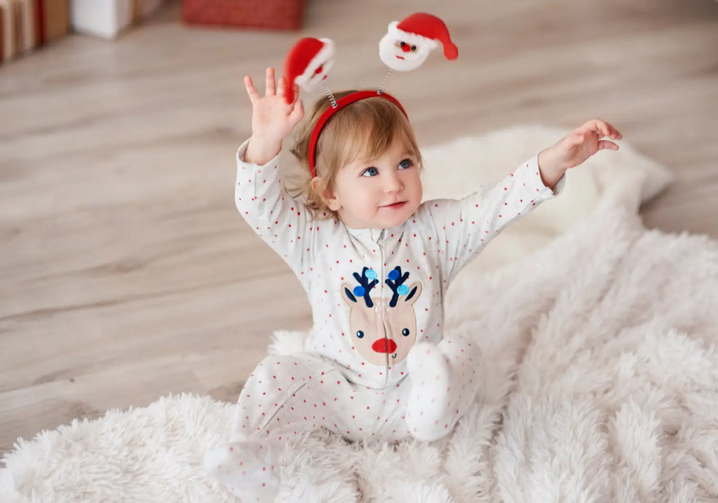 A cute baby with hands raised