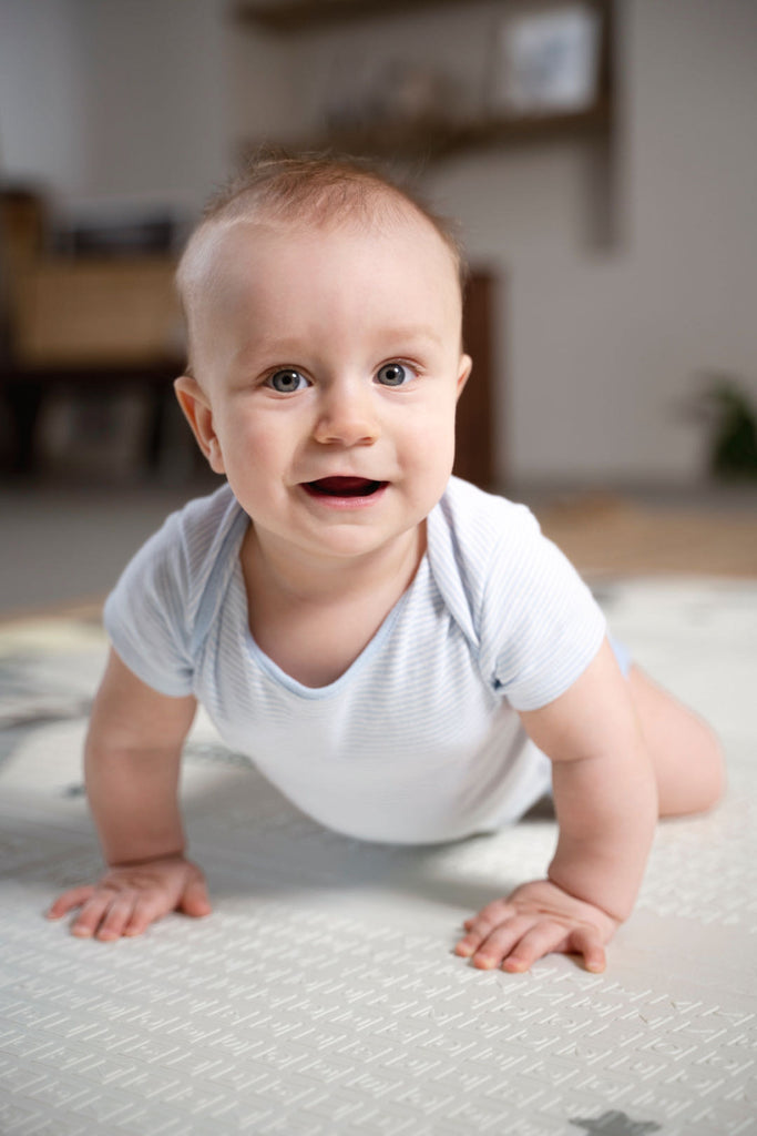 An excited baby on the floor
