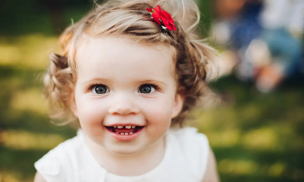 Close up face smiling beautiful baby girl nature summer while posing camera