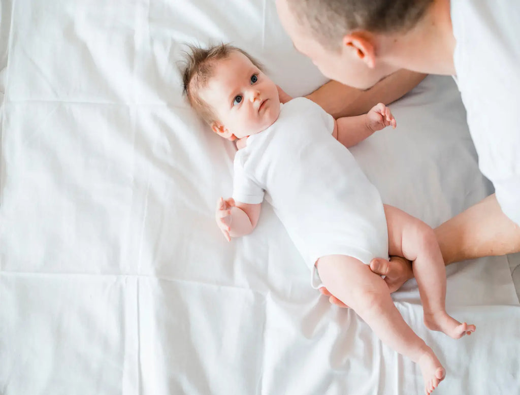 Father softly embracing baby