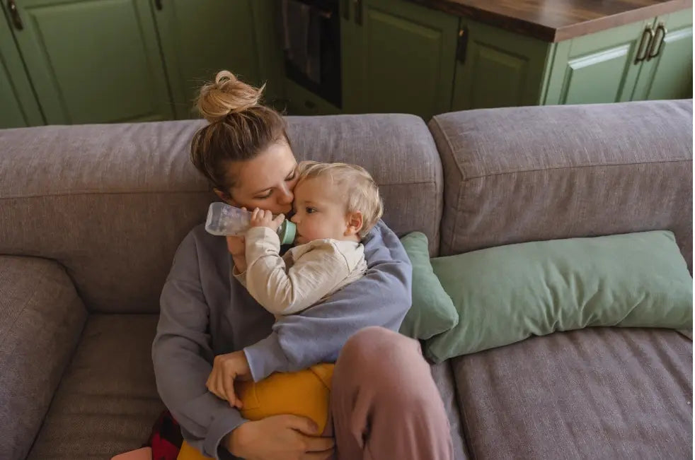 Mom Cuddle Bottle Drinking Baby