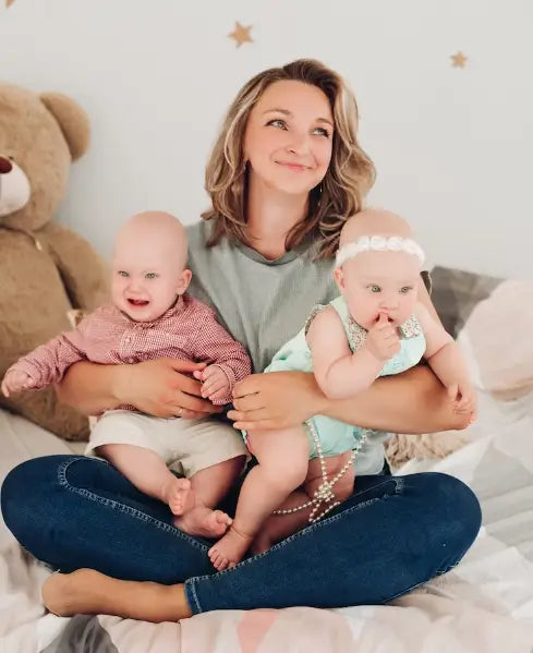 Mom Embraces Two Babies