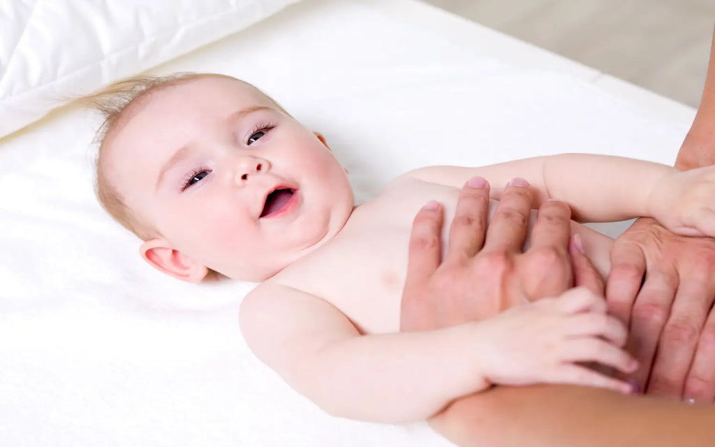Mother massaging newborn baby