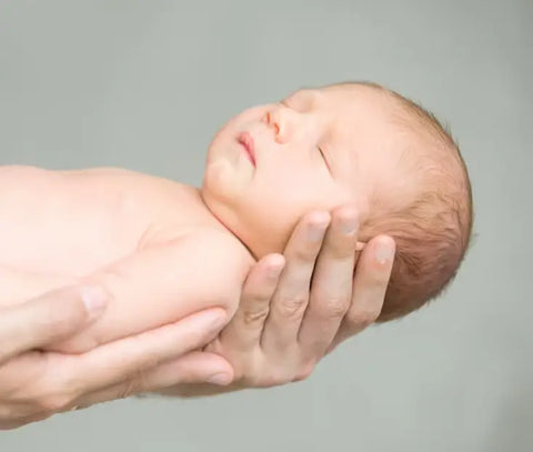 Portrait-of-a-Sleeping-Newborn-Hold-at-Hands