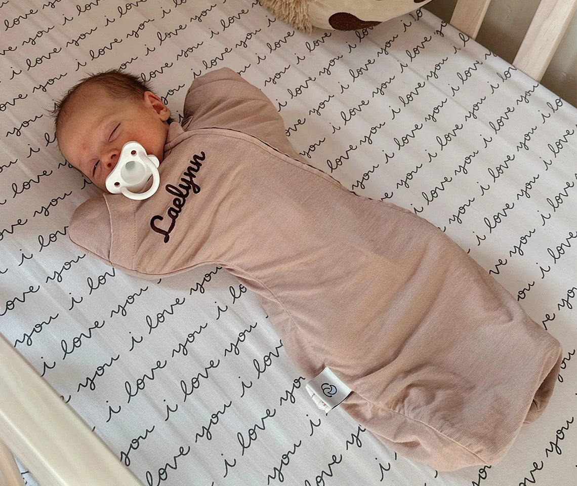 a baby in a Kaiyababy swaddle